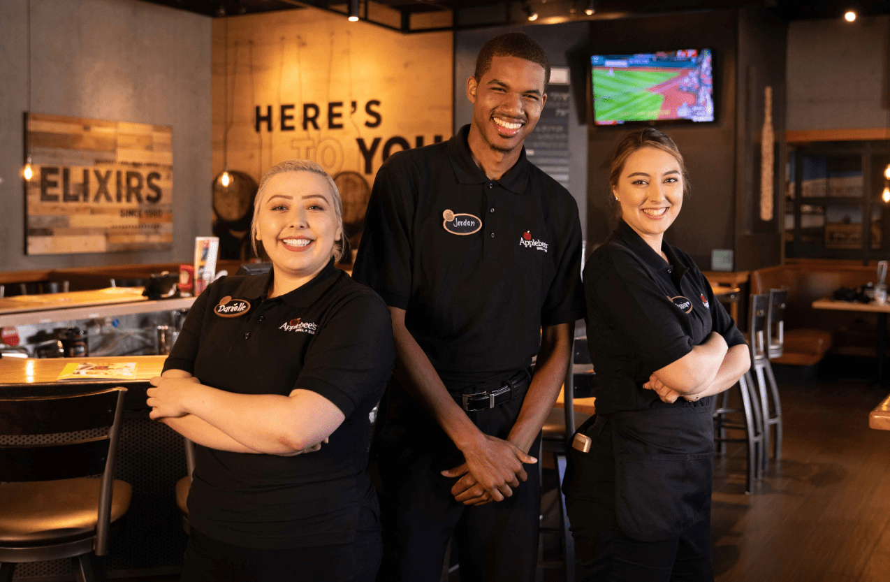 Homepage hero image of three Applebee's Franchise employees